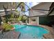 Backyard features a screened-in pool, lush landscaping, and ample seating for outdoor relaxation at 7101 N 18Th St, Tampa, FL 33610