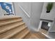 Carpeted stairway features neutral color scheme, leading to the home's upper level at 7101 N 18Th St, Tampa, FL 33610