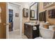 Bathroom features a stylish vanity with dark wood cabinets, granite countertop, and a decorative mirror at 7427 Baltusrol Dr, New Port Richey, FL 34654
