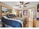 Comfortable bedroom featuring a ceiling fan, warm tones, and ample closet space at 7427 Baltusrol Dr, New Port Richey, FL 34654