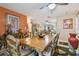 Open dining room with a wood table, tile flooring, and an adjacent living space at 7427 Baltusrol Dr, New Port Richey, FL 34654