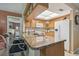 Kitchen featuring an island with seating, and wooden cabinets with granite countertops at 7427 Baltusrol Dr, New Port Richey, FL 34654