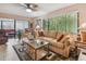 Bright living room featuring a comfortable seating area, modern decor, and access to a sunroom at 7427 Baltusrol Dr, New Port Richey, FL 34654