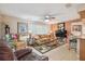Comfortable living room with tile flooring, neutral walls, and access to the kitchen at 7427 Baltusrol Dr, New Port Richey, FL 34654
