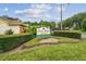 Entrance to the Hunt Ridge community with lush landscaping and a welcoming sign at 7427 Baltusrol Dr, New Port Richey, FL 34654