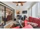 View of a sunroom featuring a red sofa, a workspace, and tile floors, enhancing indoor-outdoor living at 7427 Baltusrol Dr, New Port Richey, FL 34654