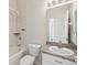 Bright bathroom featuring a bathtub and shower combo, vanity sink, and tiled walls at 7427 Wimpole Dr # 7427, New Port Richey, FL 34655