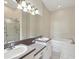 Bright bathroom featuring a double sink vanity, bathtub, and glass shower at 7427 Wimpole Dr # 7427, New Port Richey, FL 34655