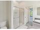 Bathroom featuring a glass door shower and views to the lanai at 7427 Wimpole Dr # 7427, New Port Richey, FL 34655