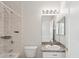 Bathroom featuring a bathtub and shower with neutral tiled walls and a vanity sink at 7427 Wimpole Dr # 7427, New Port Richey, FL 34655