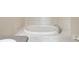 Large soaking tub with white tiled surround at 7427 Wimpole Dr # 7427, New Port Richey, FL 34655
