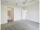 This bedroom features two doorways that lead to the walk-in closet and Primary bathroom at 7427 Wimpole Dr # 7427, New Port Richey, FL 34655