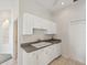 Kitchen featuring white cabinets, sink, and dishwasher at 7427 Wimpole Dr # 7427, New Port Richey, FL 34655