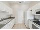 White kitchen featuring appliances and tile flooring at 7427 Wimpole Dr # 7427, New Port Richey, FL 34655