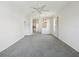 Spacious living room with ceiling fan and chandelier, blending comfort with elegant lighting at 7427 Wimpole Dr # 7427, New Port Richey, FL 34655