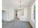 Bright and spacious living room features gray carpet and adjacent rooms at 7427 Wimpole Dr # 7427, New Port Richey, FL 34655