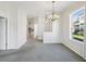 Spacious living room with gray carpet, neutral walls, and natural light from a large window at 7427 Wimpole Dr # 7427, New Port Richey, FL 34655