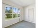 Brightly lit room with a large window looking out onto lush greenery, enhancing its serene ambiance at 7427 Wimpole Dr # 7427, New Port Richey, FL 34655