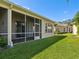 Screened-in patio overlooking backyard with green grass at 7427 Wimpole Dr # 7427, New Port Richey, FL 34655
