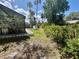 Expansive backyard bordered by lush greenery, offering ample space for gardening and outdoor activities at 7444 Candlelight Ct, New Port Richey, FL 34652