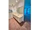 Bathroom featuring a double sink vanity with a large mirror and neutral walls at 7444 Candlelight Ct, New Port Richey, FL 34652