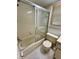A compact bathroom features a tiled shower with sliding doors and a standard toilet at 7444 Candlelight Ct, New Port Richey, FL 34652