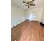 A bright bedroom with wood flooring, a fan, and closet, perfect for a relaxing retreat at 7444 Candlelight Ct, New Port Richey, FL 34652