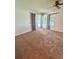 Cozy bedroom with carpet, ceiling fan, and a glass door leading to the outside at 7444 Candlelight Ct, New Port Richey, FL 34652