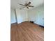 Light-filled bedroom features wood floors, closet space and ample natural light at 7444 Candlelight Ct, New Port Richey, FL 34652