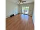 A spacious bedroom with wood flooring, fan, closet and sliding doors leading to a porch at 7444 Candlelight Ct, New Port Richey, FL 34652