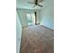 Bedroom with carpet, ceiling fan and access to the exterior at 7444 Candlelight Ct, New Port Richey, FL 34652