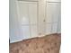 Bedroom closets with white doors and carpet flooring at 7444 Candlelight Ct, New Port Richey, FL 34652