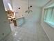 Bright dining area with tiled floors adjacent to the kitchen; skylight above at 7444 Candlelight Ct, New Port Richey, FL 34652