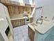 Bright kitchen with retro wood cabinets, tiled floor and skylight at 7444 Candlelight Ct, New Port Richey, FL 34652