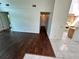 Open floor plan connecting the living area to the kitchen with tile and wood floors at 7444 Candlelight Ct, New Port Richey, FL 34652