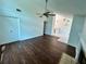 Spacious living area with wood floors, connecting to kitchen and dining space at 7444 Candlelight Ct, New Port Richey, FL 34652