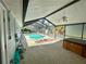 View of screened-in pool and outdoor seating area, from outdoor patio area at 7444 Candlelight Ct, New Port Richey, FL 34652