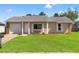 Charming single-story home with a well-manicured lawn, decorative stone accents, and an attached garage at 8341 Corney Dr, Port Richey, FL 34668