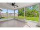 A screened porch offers an inviting view of a lush backyard with trees providing privacy and shade at 8341 Corney Dr, Port Richey, FL 34668