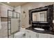 Updated bathroom offers a modern glass-enclosed shower with luxurious vanity and marble countertops at 8516 Wooddrift Dr, Tampa, FL 33615