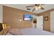 Bedroom featuring TV, ceiling fan, and door to hallway and closets at 8516 Wooddrift Dr, Tampa, FL 33615