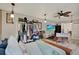 Spacious bedroom with open closet, natural light, tile floors, ceiling fan, and entertainment center at 8516 Wooddrift Dr, Tampa, FL 33615