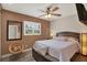 Well lit bedroom with light hardwood floors, ceiling fan, and shuttered window at 8516 Wooddrift Dr, Tampa, FL 33615