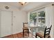Breakfast nook featuring table and two chairs near window with view to backyard at 8516 Wooddrift Dr, Tampa, FL 33615