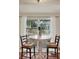 Breakfast nook featuring table and two chairs near window with view to backyard at 8516 Wooddrift Dr, Tampa, FL 33615