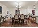 Bright dining room featuring chandelier, table with six chairs and tiled floor at 8516 Wooddrift Dr, Tampa, FL 33615