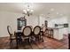 Dining area with chandelier in open concept to the adjacent kitchen with island seating at 8516 Wooddrift Dr, Tampa, FL 33615