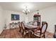 Dining room with chandelier, and table with six chairs situated on a tiled floor at 8516 Wooddrift Dr, Tampa, FL 33615