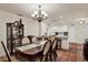 Dining area with chandelier and open concept to the adjacent kitchen and its granite countertop at 8516 Wooddrift Dr, Tampa, FL 33615