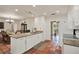 Bright open concept kitchen, connecting to dining area, featuring white cabinets at 8516 Wooddrift Dr, Tampa, FL 33615